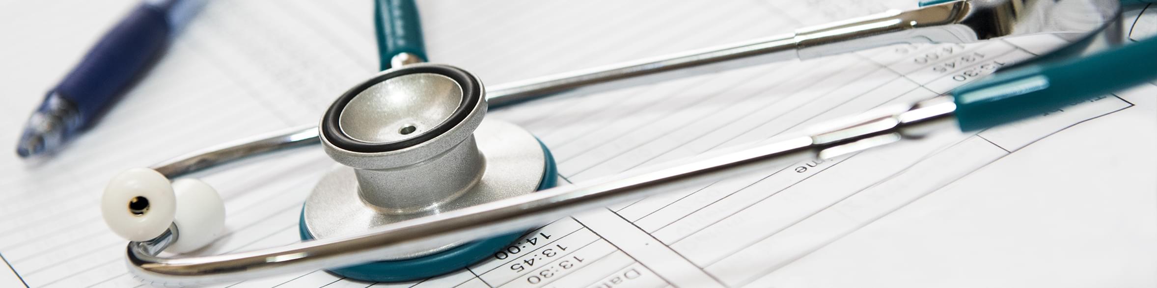 Medical Coding Certificate Program (stethoscope on top of Medical Coding Forms)