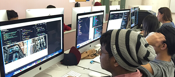 Computer Technology students writing code in a computer lab