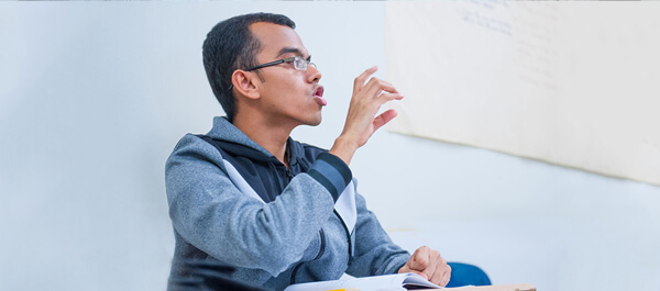 LA: Deaf Studies Option: student practicing signing in a classroom