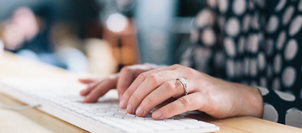 Student using a keyboard to type for digital journalism