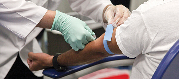 Healthcare professional taking blood