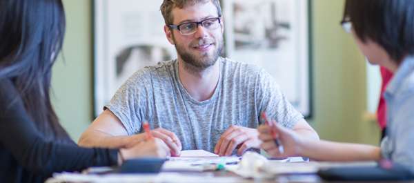 English: students around a table in a study group
