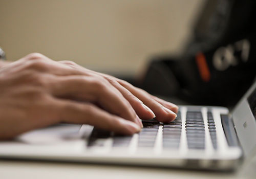 Showing hands on a computer keyboards