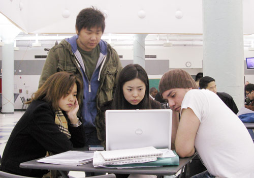 Students gathering at atrium for group assignment
