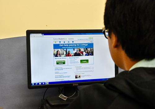 Student in front of a computer applying for Federal Student Aid
