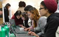 Students using laptops to find needed information