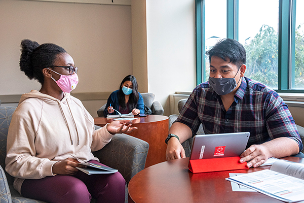 two students sitting and talking