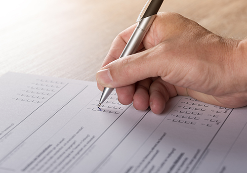 Person filling out a voting ballot