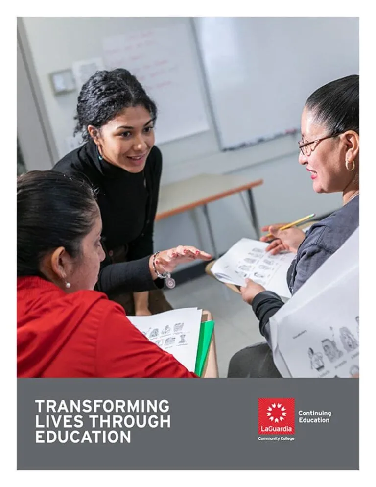 A counselor talking to two students in a classroom