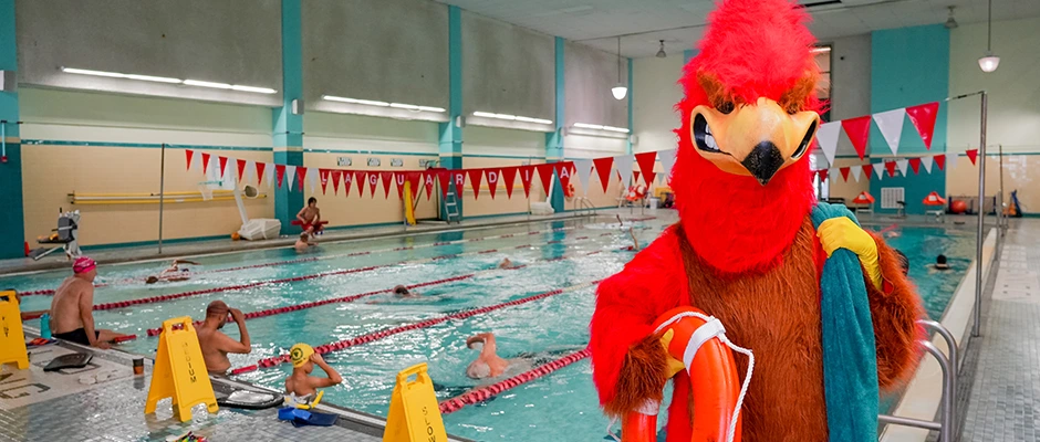 Rebel Mascot posing as a life guard at the Pool