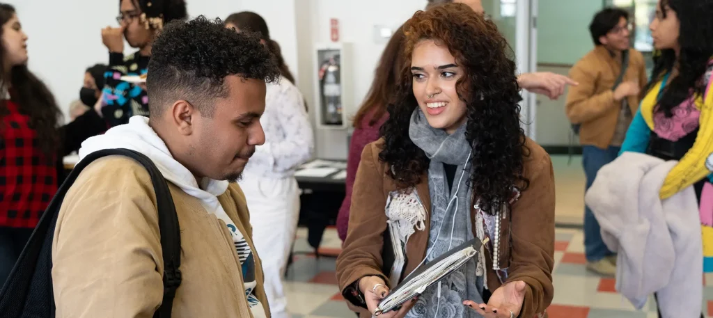 Students conversing in a conference room