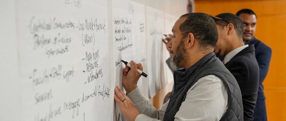 Faculty and Staff writing on a white board
