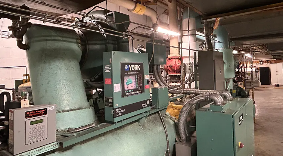 E Building ChillerBuilding chillers are refrigeration systems used to cool large spaces by circulating chilled water through a building's HVAC system.  Building Operations monitors all campus building chiller/cooling systems to control building temperatures and increase energy efficiency.