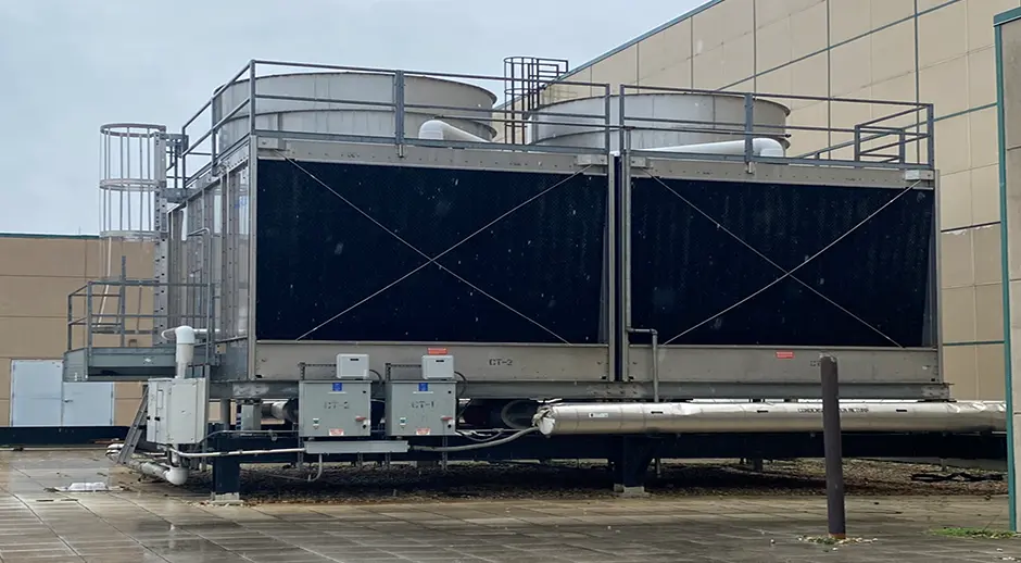E Building Cooling TowersCooling towers for the E Building remove heat from the chiller system to provide comfortable indoor temperatures.  The towers cool water through evaporation before returning cold water to the chiller, completing the cooling cycle.