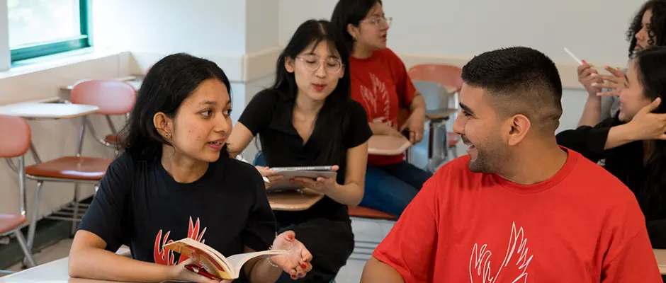 Students in a classroom learning and talking to each other